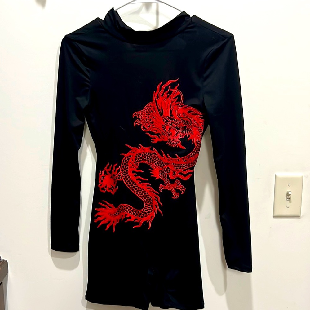 NWT. Fashion nova black romper with Dragon design. Never worn.
